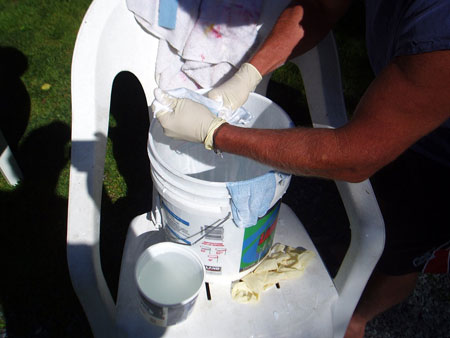 Dipping cloth strips into glue bucket - white glue slightly dilluted with water.