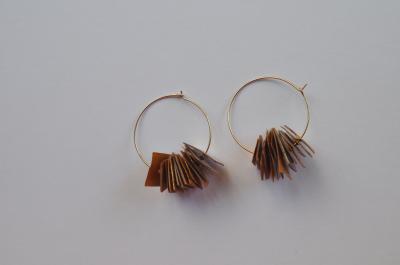 "Gold earrings from recycled paper" by Minna Ben-Nun