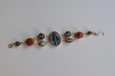 "Prestigious bracelet gemstones embedded in different sizes and colors" by Minna Ben-Nun